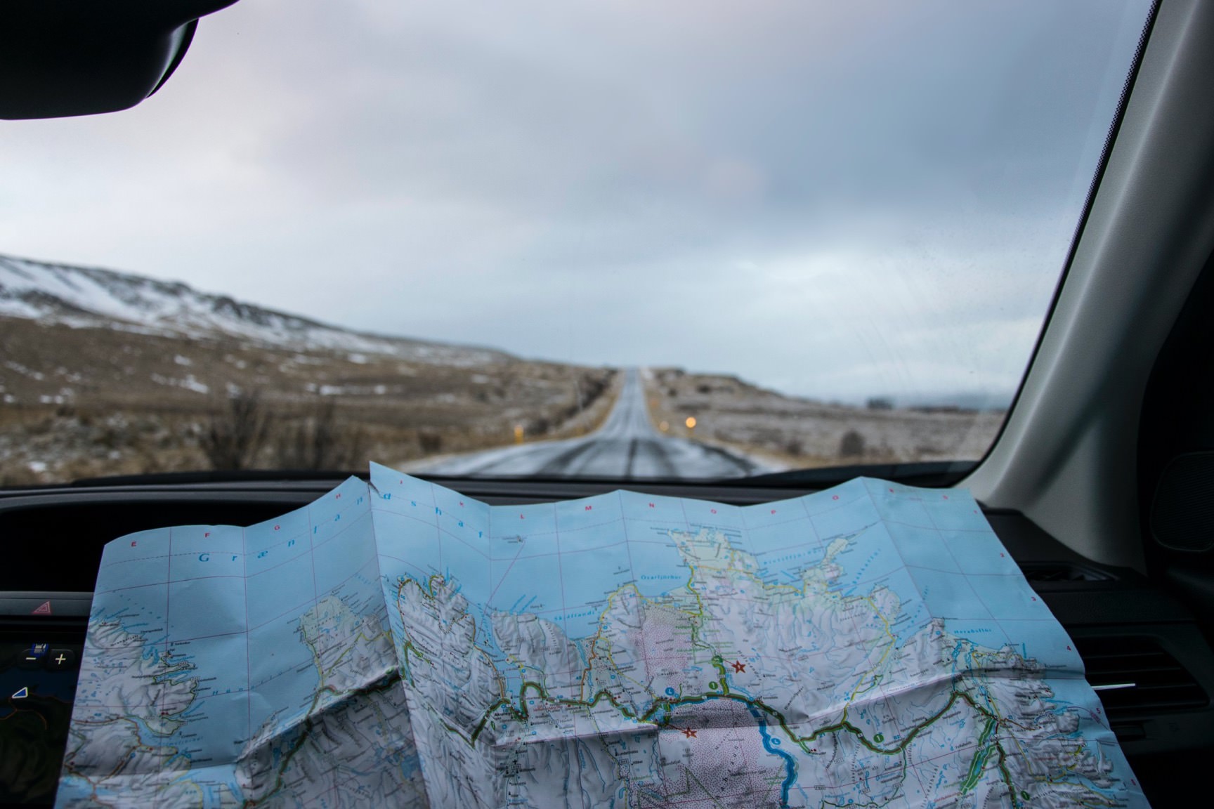 Map spread open on car dashboard